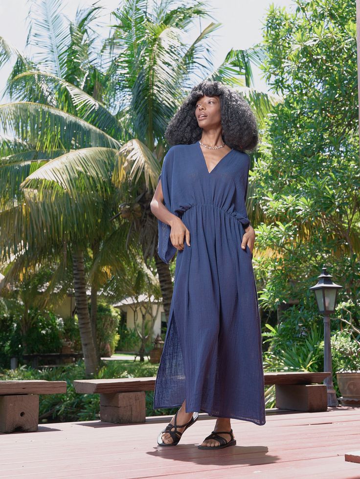 Introducing our Acacia Cotton Linen Goddess Dress in navy, a stunning addition to our Goddess Collection. This dress is lovingly handcrafted with 100% cotton-linen and is ideal for both casual beach days and elegant nights out. The elastic waistband and bat-wing sleeves offer a feminine, bohemian style, while the lightweight fabric and two side pockets ensure comfort and versatility. Plus, the self-belt highlights the waist for a flattering touch. Features: Soft cotton linen-blend, no lining Ela Chic Cotton Maxi Dress For Beach Cover-up, Navy V-neck Vacation Dress, Cotton V-neck Beach Dress For Day Out, Unlined Cotton Maxi Dress For Summer, Blue Linen Summer Dress For Day Out, Chic Cotton Maxi Dress For The Beach, Indigo V-neck Summer Dress, Blue Linen Dress For Summer Day Out, Blue Linen Dress For Day Out