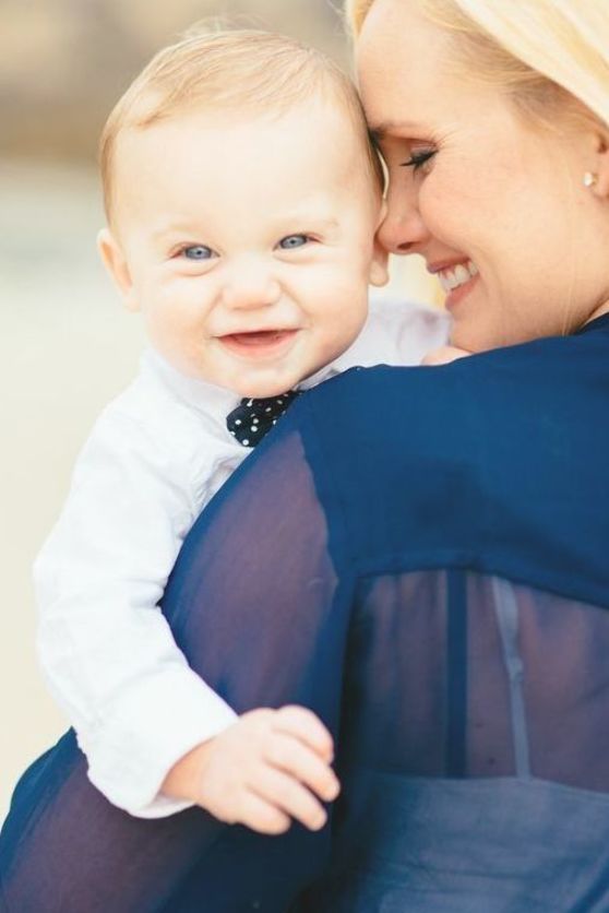 a woman holding a baby in her arms