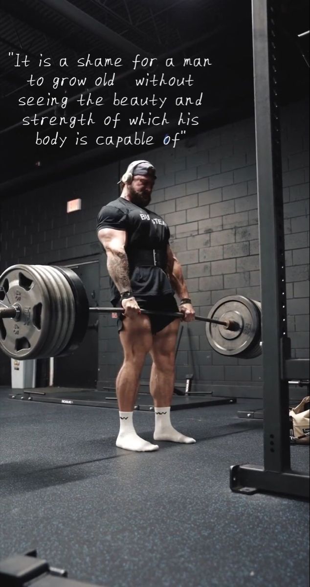 a man standing in front of a barbell