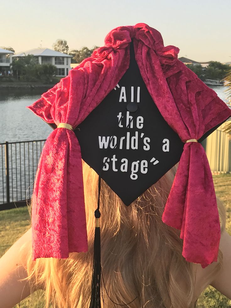 a woman wearing a graduation cap that says, all the world's a stage