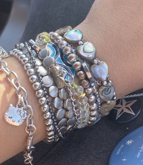 Silver Arm Jewelry, Bracelet Y2k Aesthetic, Lots Of Bracelets On Wrist Aesthetic, Silver Jewellery Layering, Lots Of Silver Jewelry Aesthetic, Silver Jewelry Stacking, Chunky Bracelets Aesthetic, Y2k Bracelets Aesthetic, Multiple Bracelets Style