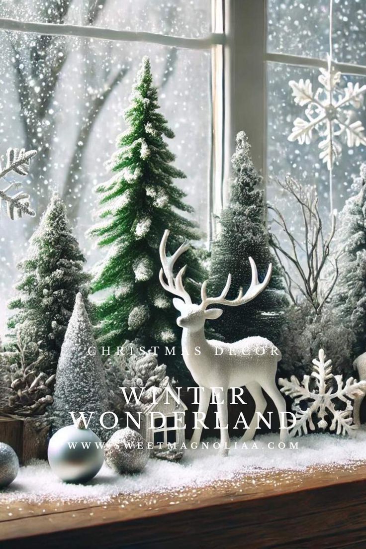 a christmas scene with snow, trees and deer in front of a window sill