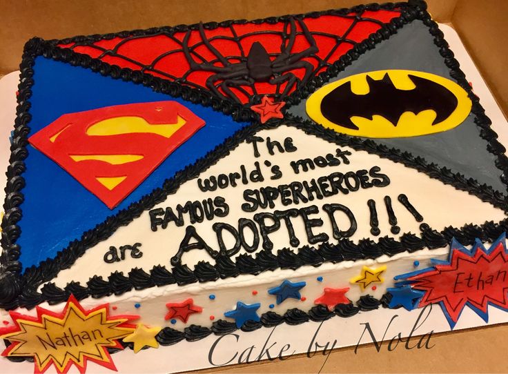 a birthday cake decorated with batman, supermans and spider - man symbols on it