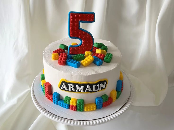 a birthday cake with legos on it and the number five for armaann