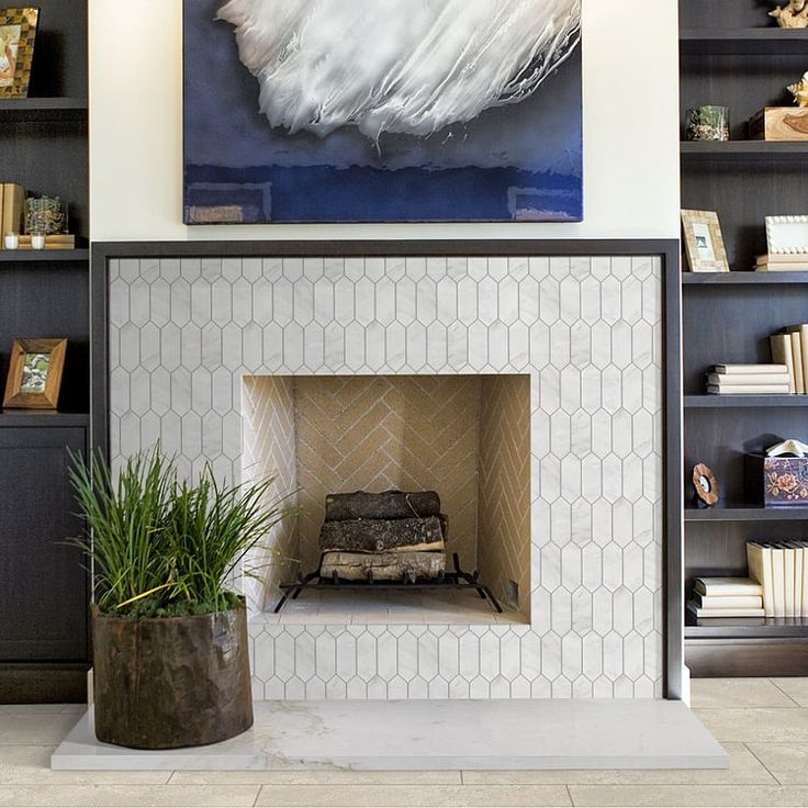 a living room with a fire place and bookshelves