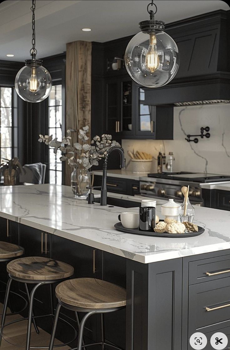 a large kitchen with marble counter tops and bar stools in front of the island