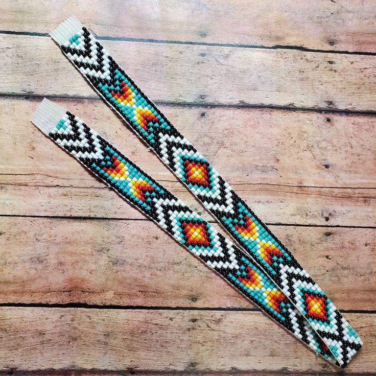 two bracelets sitting on top of a wooden table