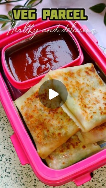 a pink plastic container filled with food and sauce