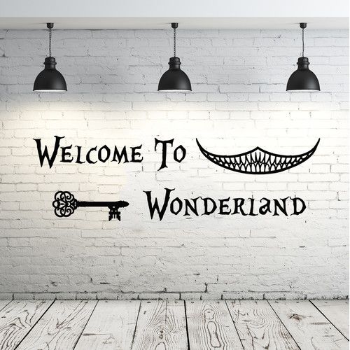 welcome to wonderlandland wall decal in an empty room with brick walls and wooden floors