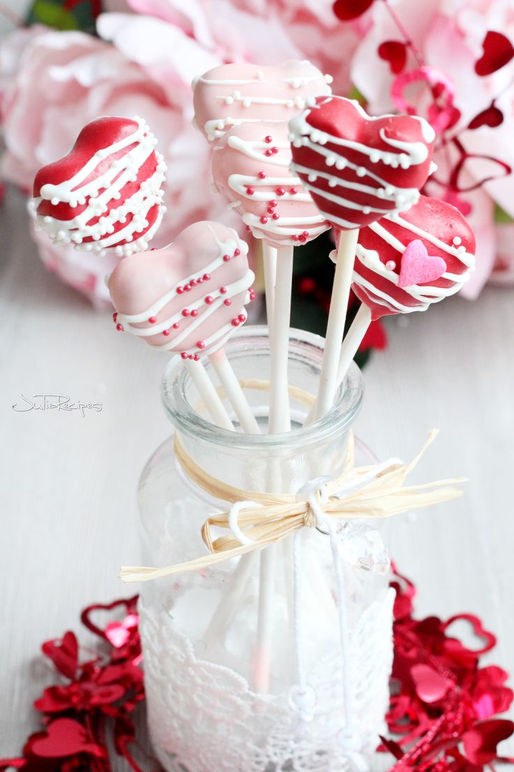 heart shaped lollipops in a jar on a table