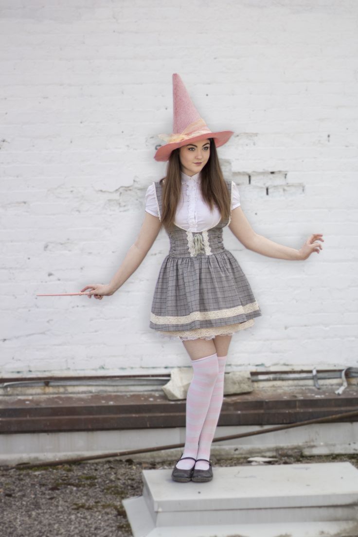 a woman in a dress and hat standing on a step