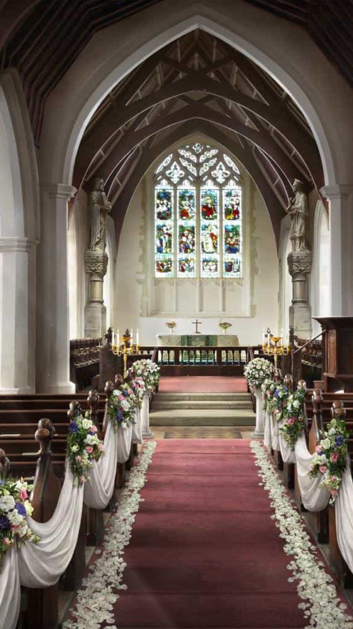 the aisle is decorated with flowers and ribbons