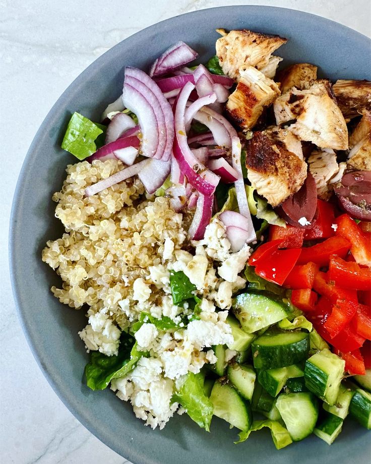 a bowl filled with meat, vegetables and rice