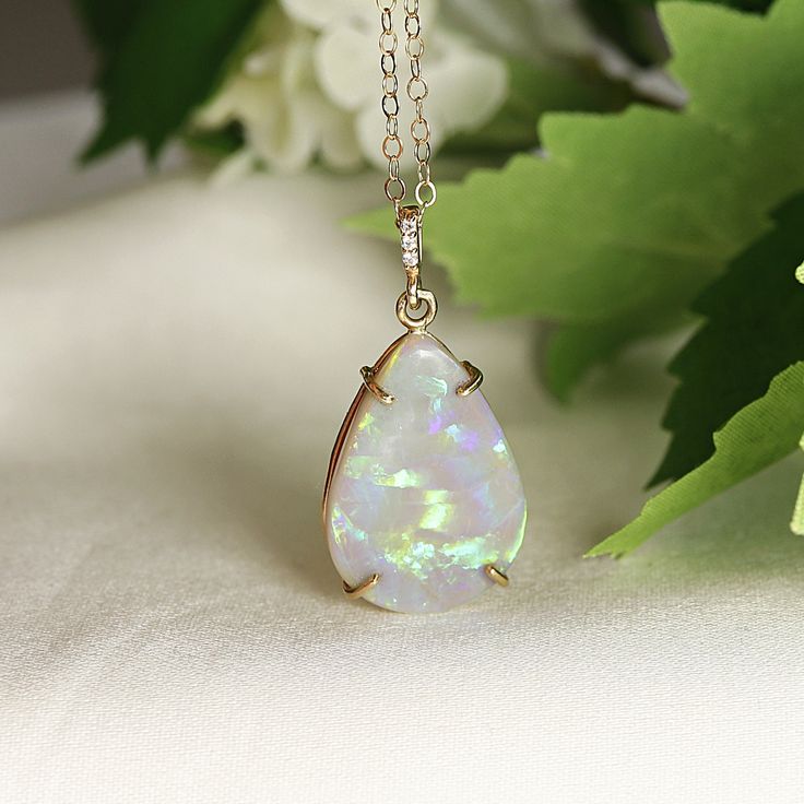 "Pear cabochon shaped beautiful Australian opal pendant necklace. It's featured on 14k yellow solid gold handmade prong setting, diamond bail and 14k yellow solid gold chain. Opal is pear shaped cab cut and unique. DETAILS  Opal is genuine Australian opal and pear shaped. Pendant size : 21.5mm height, 14.5mm width Bails has 3 diamonds total 0.01 ct.  It's coming with 16' to 18\" adjustable 14k solid gold chain.  All our raw materials are sourced from US-based companies for the quality and safety Formal Opal Necklace With 17 Jewels, Teardrop Cabochon Necklace For Anniversary, Drop Shaped Cabochon Jewelry For Anniversary, Formal Opal Pendant Jewelry, Pear-shaped Opal Jewelry For Formal Occasions, Formal Opal Pear-shaped Jewelry, Anniversary Teardrop Cabochon Necklace, Anniversary Cabochon Teardrop Necklace, Formal Pear-shaped Opal Jewelry