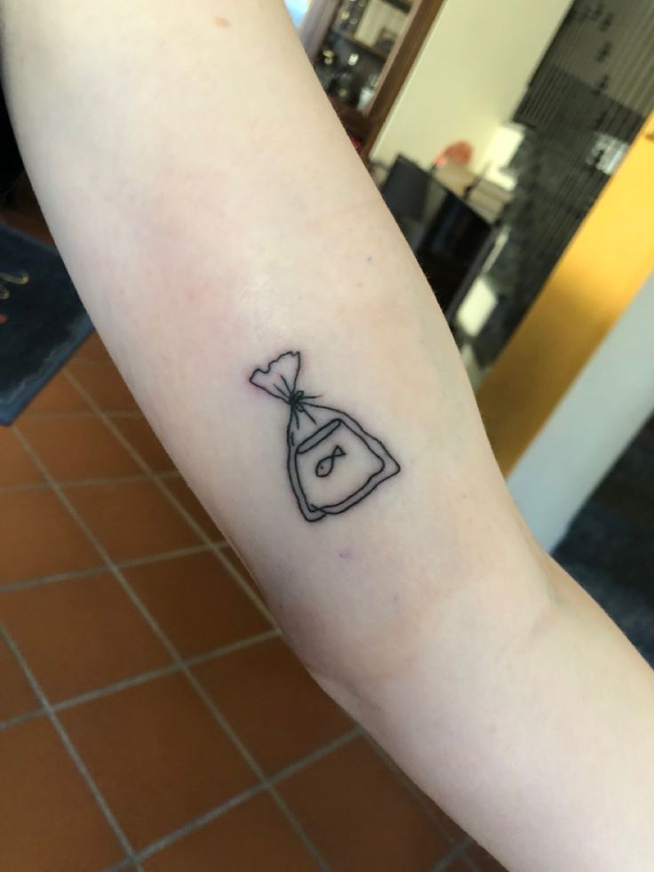 a person with a small tattoo on their arm