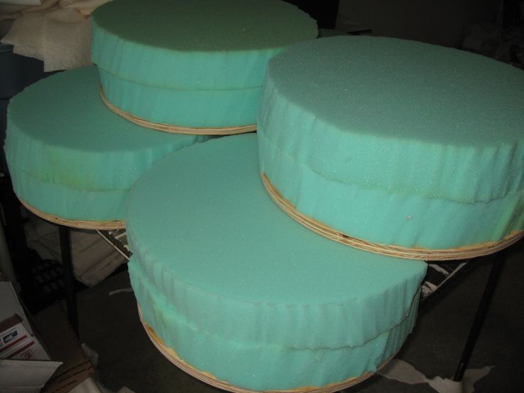 several round green cushions stacked on top of each other