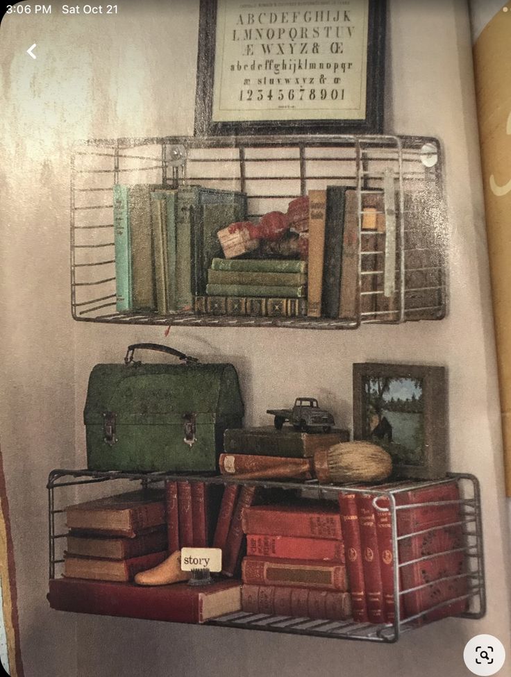 there are many books and suitcases on the shelves in this bookcase with pictures above them