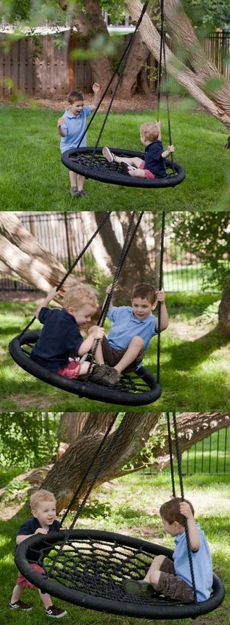 two children sitting on swings in the yard, one is playing with his toy and another is