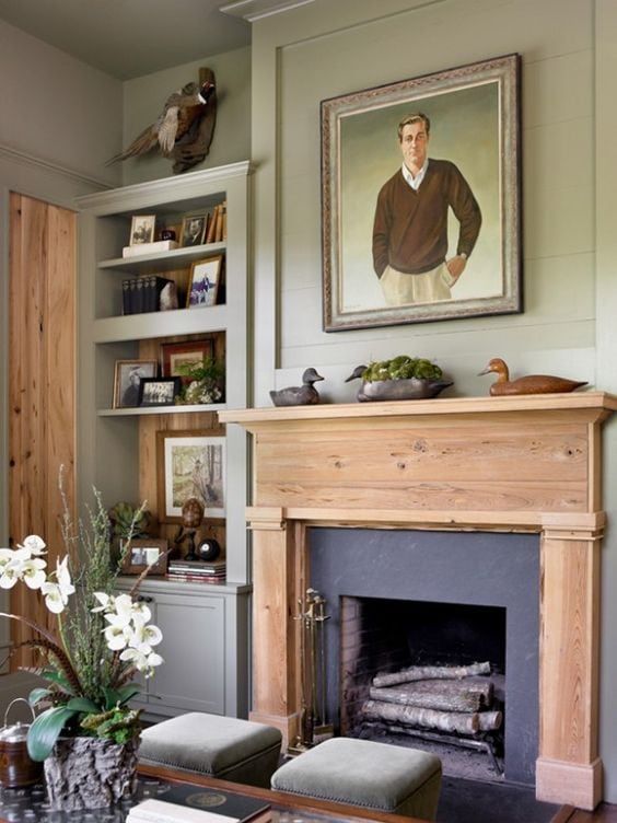 a living room filled with furniture and a painting on the wall above a fire place