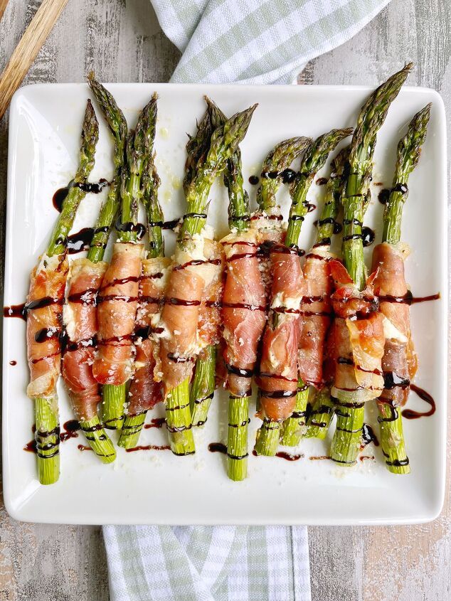 asparagus wrapped in bacon on a white plate