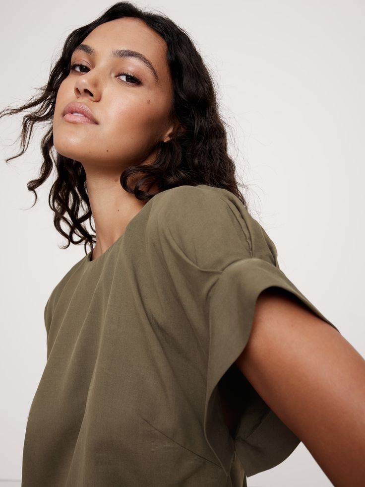 We cut this relaxed top with hidden pleats at the cuffs to create an almost-puffed sleeve silhouette.  For fabric, we reached for one of our favorite all-season twills, woven from silky soft Tencel™ lyocell and breathable cotton.  Relaxed fit.  Sustainability: Made with TENCEL™ lyocell, a sustainably sourced fiber from responsibly-harvested trees.  Crew neck with button-keyhole at back.  Straight hem.  Unlined.  Relaxed fit.  Short sleeves.  Hip length.  Model: Size S, 5'10" (178cm). Relaxed Fit Short Sleeve Puff Sleeve Top For Fall, Fall Puff Sleeve Top With Relaxed Fit, Fall Relaxed Fit Puff Sleeve Top With Short Sleeves, Fall Relaxed Fit Short Sleeve Puff Sleeve Top, Cotton Tops With Pleated Sleeves And Relaxed Fit, Relaxed Fit Tops With Blouson Sleeves For Work, Relaxed Fit Workwear Tops With Blouson Sleeves, Relaxed Fit Blouson Sleeve Tops For Work, Effortless Relaxed Fit Viscose Top