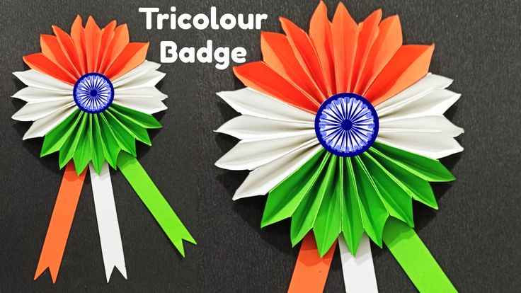 two orange, white and green ribbons with the words tricolour badge on them