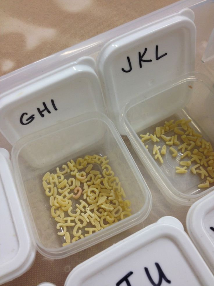 three plastic containers filled with different types of cereals and letters in them, labeled gh, jkl, u kl