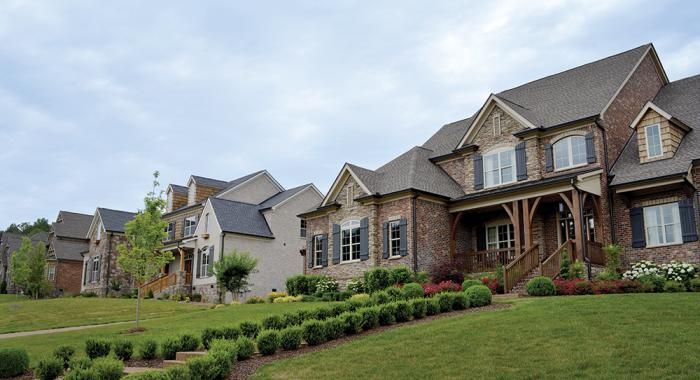 a large house with lots of windows and landscaping