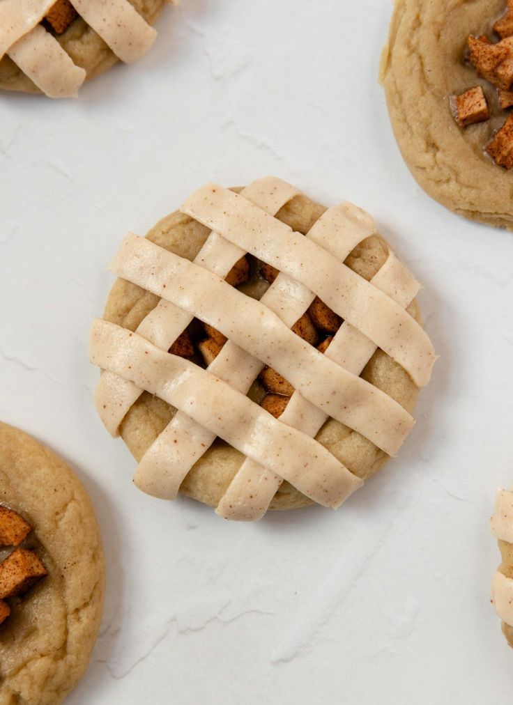 several cookies with latticed crusts on top of each one are arranged in the shape of an apple pie