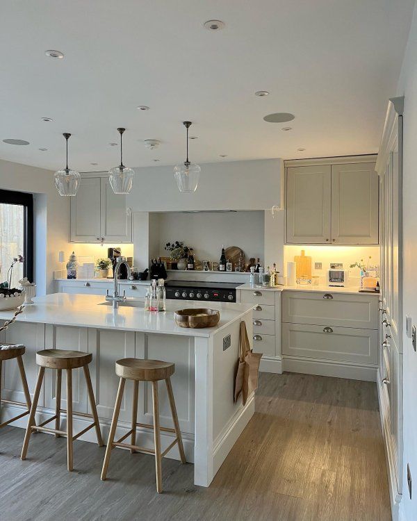 a kitchen with an island and stools in it