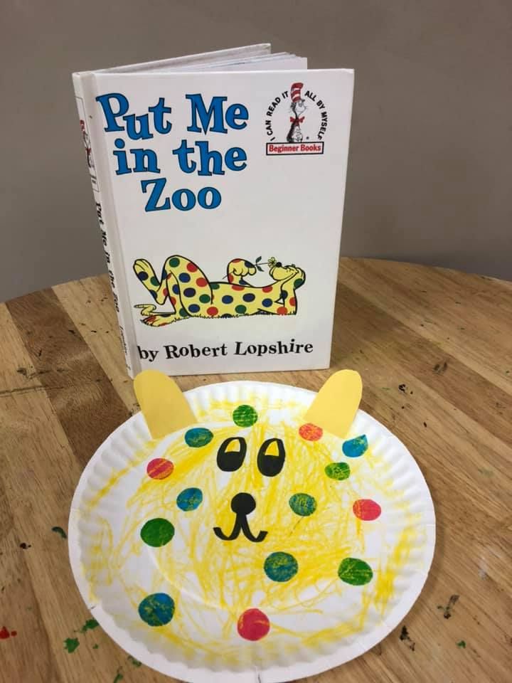 a paper plate with a book on top of it next to a children's book