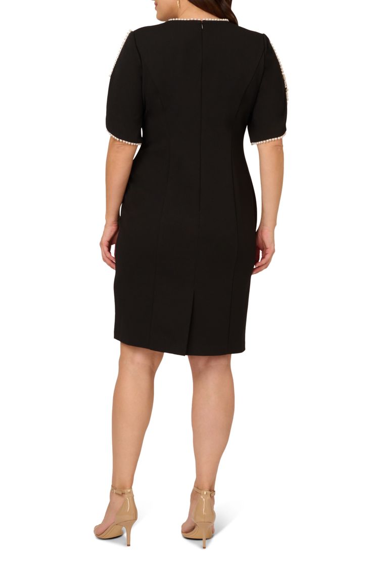 Glossy imitation pearls add a lilt of luster to this chic dress that's ready to be a part of an elegant evening out. 42" length Hidden back-zip closure Jewel neck Short sleeves Lined 95% polyester, 5% elastane Dry clean Imported Elegant Embellished Dresses For Work, Elegant Embellished Workwear Dresses, Elegant Embellished Midi Dress For Formal Occasions, Elegant Lined Midi Dress For Evening, Elegant Lined Midi Evening Dress, Elegant Embellished Formal Midi Dress, Elegant Lined Sheath Midi Dress, Elegant Sheath Lined Midi Dress, Embellished Sheath Dress For Formal Occasions