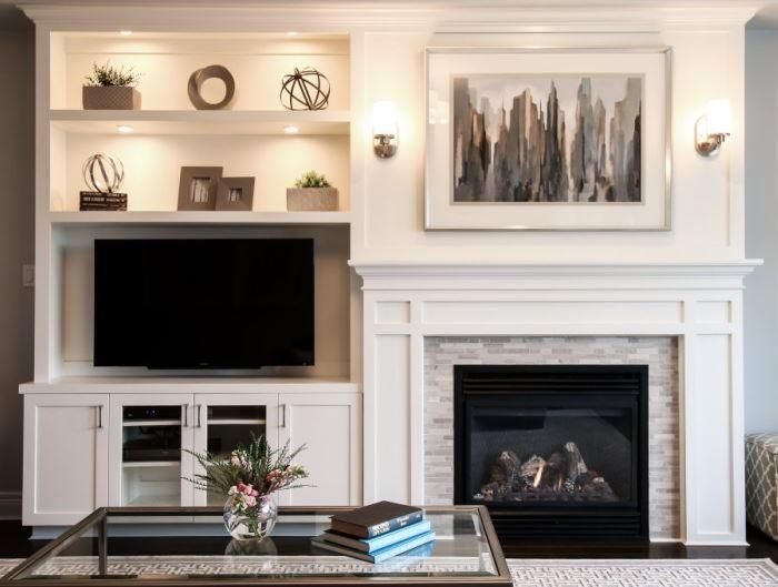 a living room with a fireplace and entertainment center