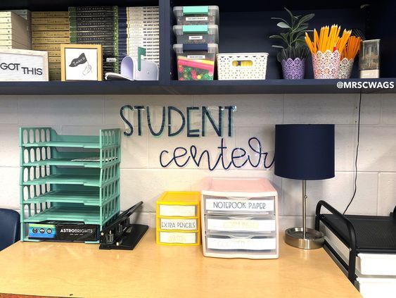 an office desk with books, binders and other items on it's shelves