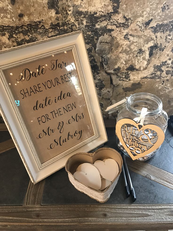 two heart shaped candles in a box next to a sign that says, date you're late idea for the new year