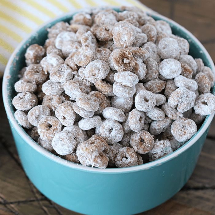 a blue bowl filled with cereal on top of a wooden table