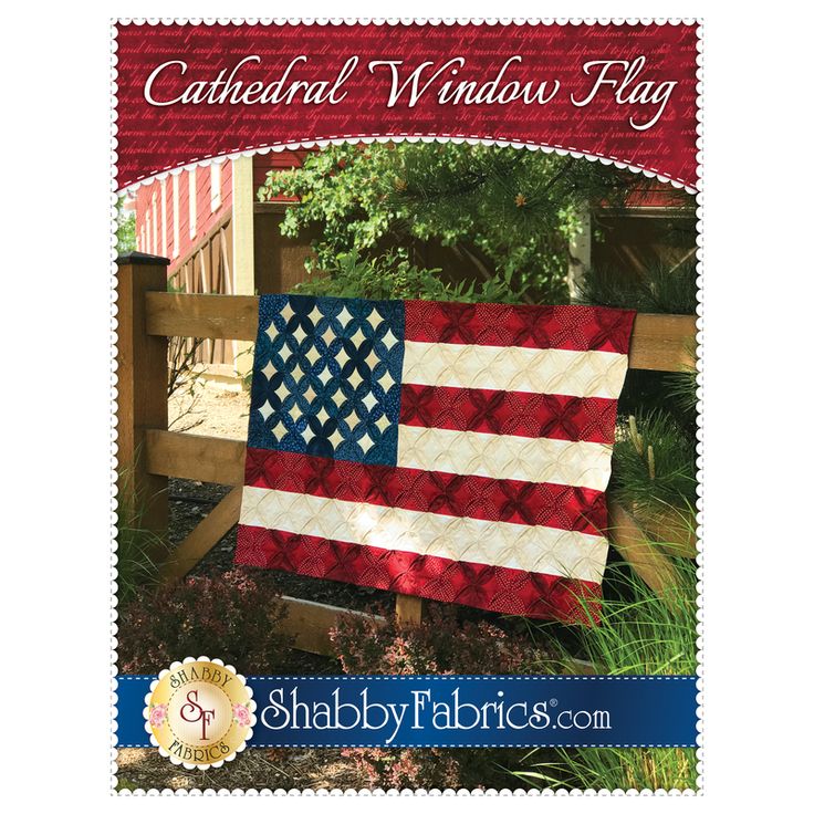 an american flag quilt hanging on a fence with the words cathedral window flag written in red, white and blue