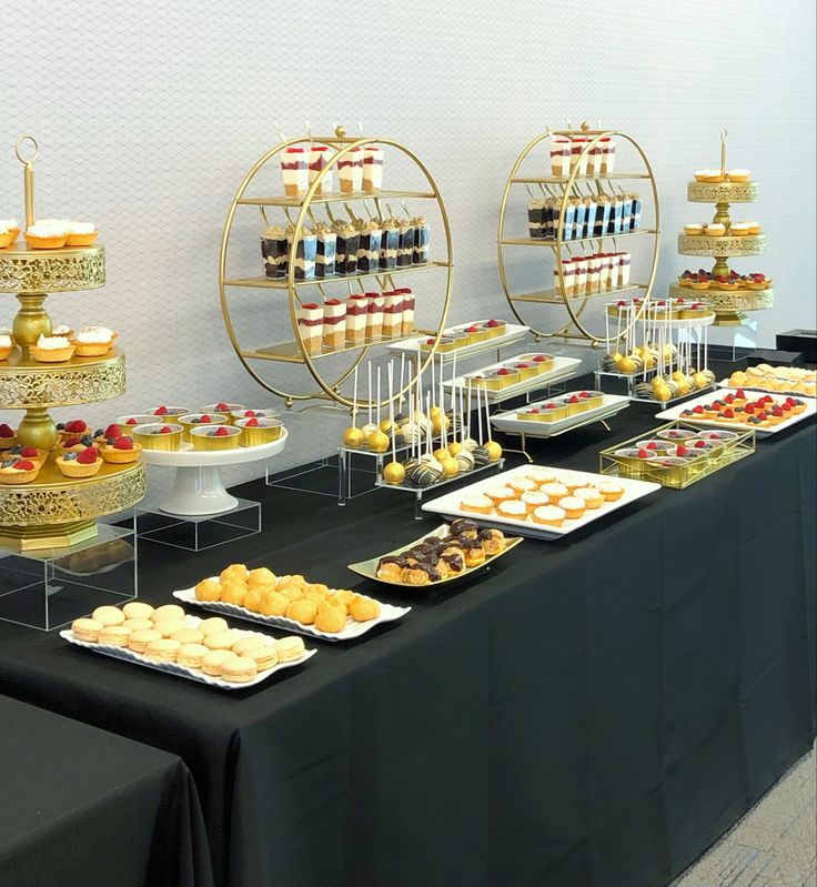 a table topped with lots of desserts and pastries