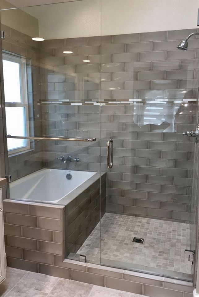 a bathroom with a walk in shower next to a bath tub