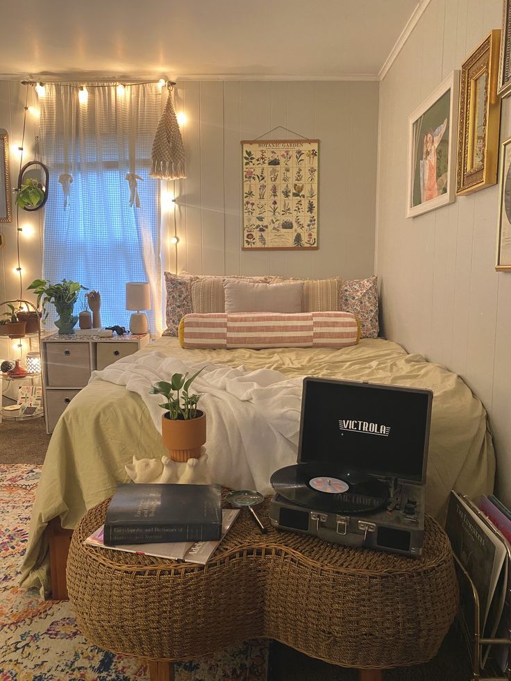 a bed room with a neatly made bed and various items on top of the bed