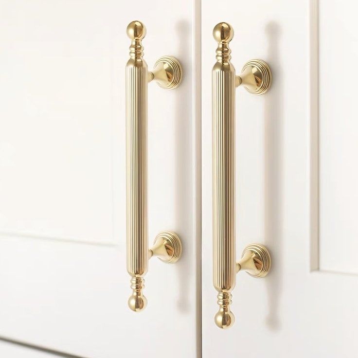 two white doors with gold handles and knobs