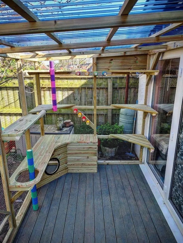 a wooden bench sitting on top of a hard wood floor next to a caged in area