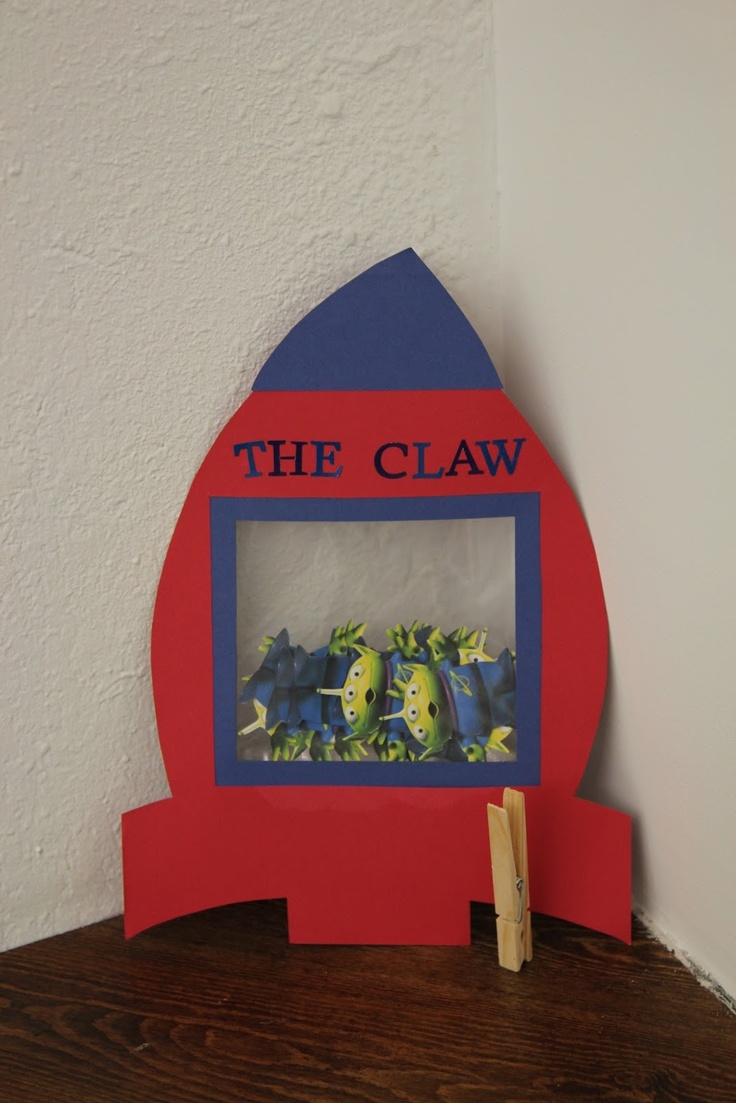 a red and blue rocket ship with the words the claw on it's side