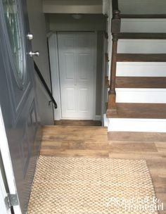 the door is open and there are stairs leading up to the front door in this house