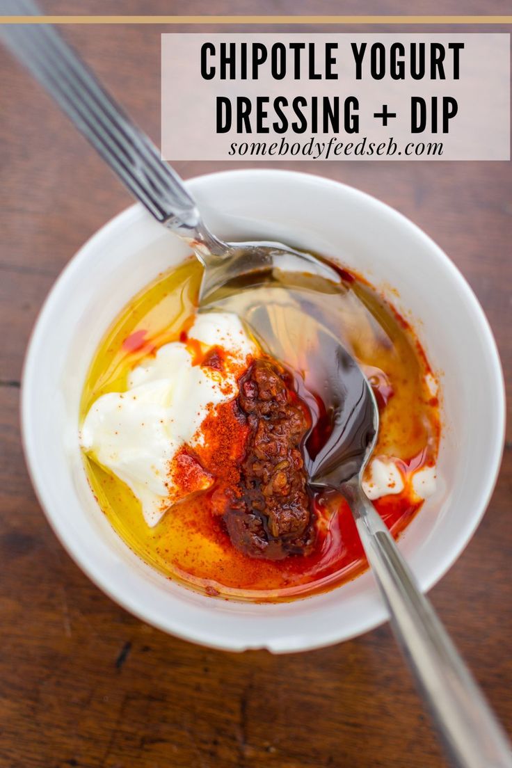 a white bowl filled with food on top of a wooden table next to a fork