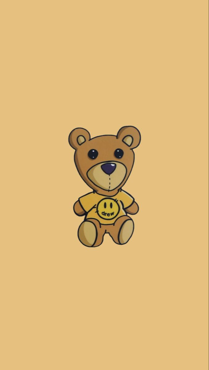 a brown teddy bear sitting on top of a yellow wall with a smiley face drawn on it