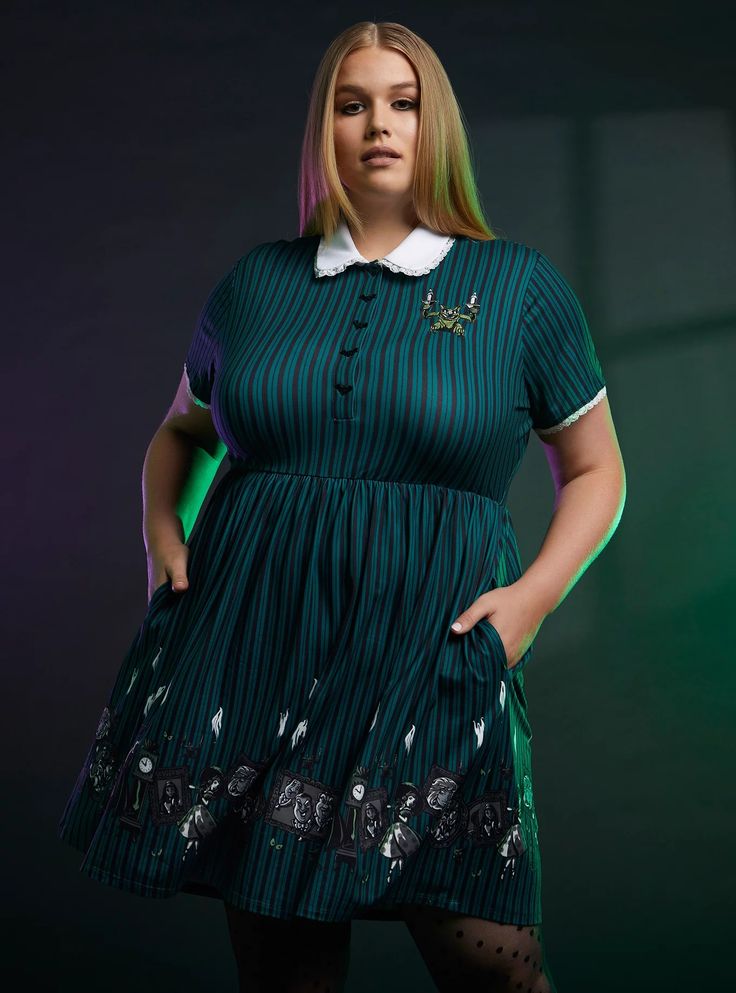 This striped, collared dress captures all the playful creepiness of The Haunted Mansion. It's green like the wallpaper, has an embroidered design of the gargoyle candelabra on the chest, and bat buttons going down the bodice. On the skirt, you'll find framed images of the mansion's most infamous spirits. Plus Size Wizard Of Oz Costumes, Glenda Dress Wizard Of Oz, Plus Size Villian Costume, Charlottes Web Fancy Dress, Mad Hatter Costume Female Plus Size, Plus Size Encanto Costume, Large Family Halloween Costumes Disney, Disney Villan Costumes For Women, Plus Size Halloween Costumes Halloween Costumes