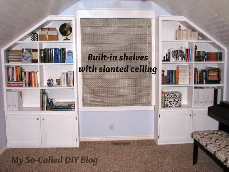 an attic bedroom with built - in shelvings, bookshelves and a bench