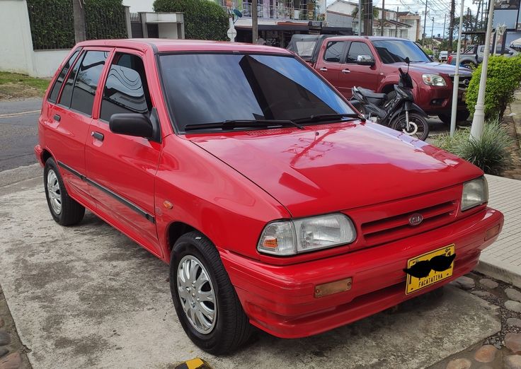 a red car is parked on the street