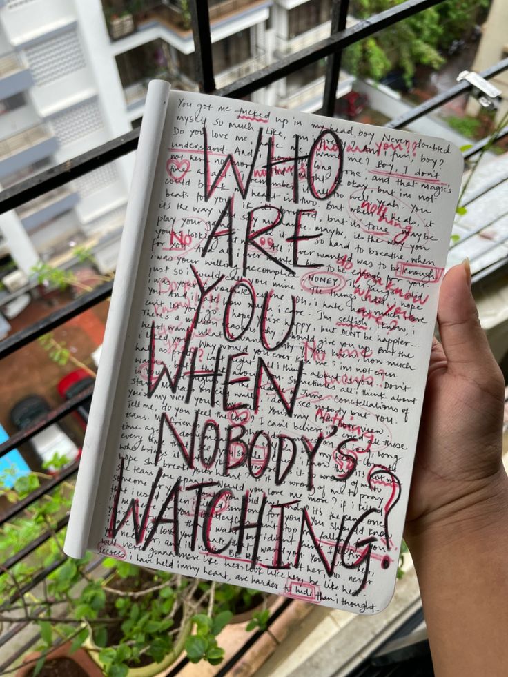 someone holding up a notebook with writing on it that says who are you when nobody's watching?